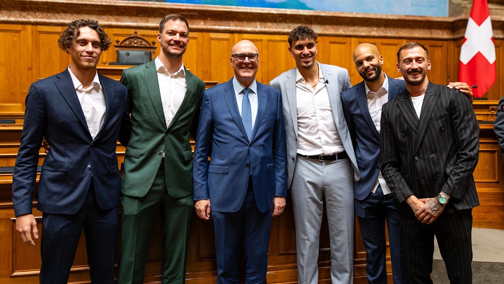 Die Basketballspieler (Silbermedaille an der 3x3-WM in Ulan Bator) umrahmen und überragen Bundesrat Martin Pfister.